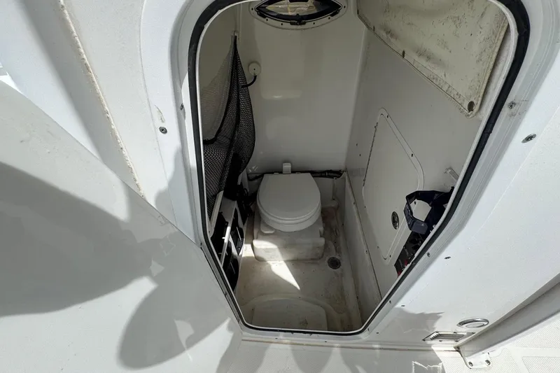 Slide: The Image of 2014 Sea Hunt Gamefish 25 boat interior with compact marine toilet. - 13