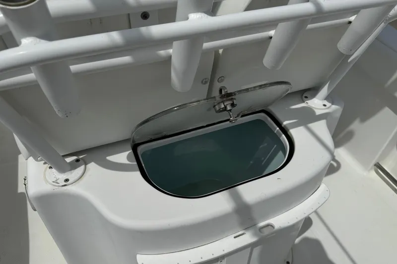 Slide: The Image of 2014 Sea Hunt Gamefish 25 livewell with open lid, showcasing interior. - 19