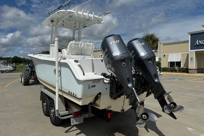 Slide: The Image of 2014 Sea Hunt Gamefish 25 boat with dual Yamaha 150 engines on a trailer. - 2