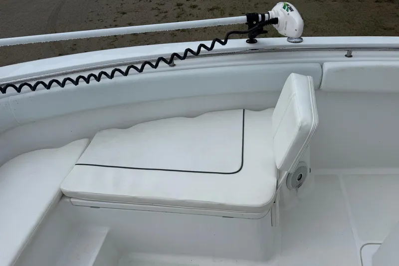 Slide: The Image of 2014 Sea Hunt Gamefish 25 boat interior with white cushioned seating. - 22