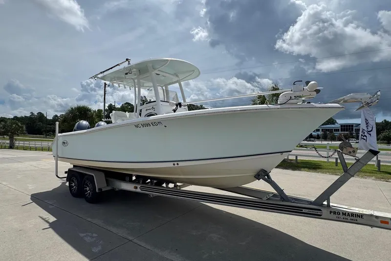Slide: The Image of 2014 Sea Hunt Gamefish 25 boat on trailer under cloudy sky. - 5
