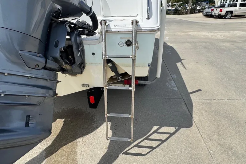 Slide: The Image of 2014 Sea Hunt Gamefish 25 boat with ladder and outboard motor on concrete surface. - 6