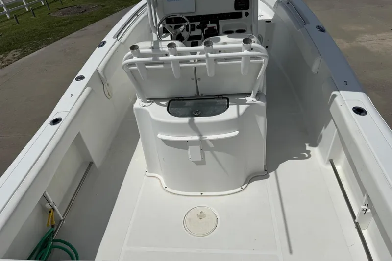 Slide: The Image of 2014 Sea Hunt Gamefish 25 boat interior with steering console and rod holders. - 7