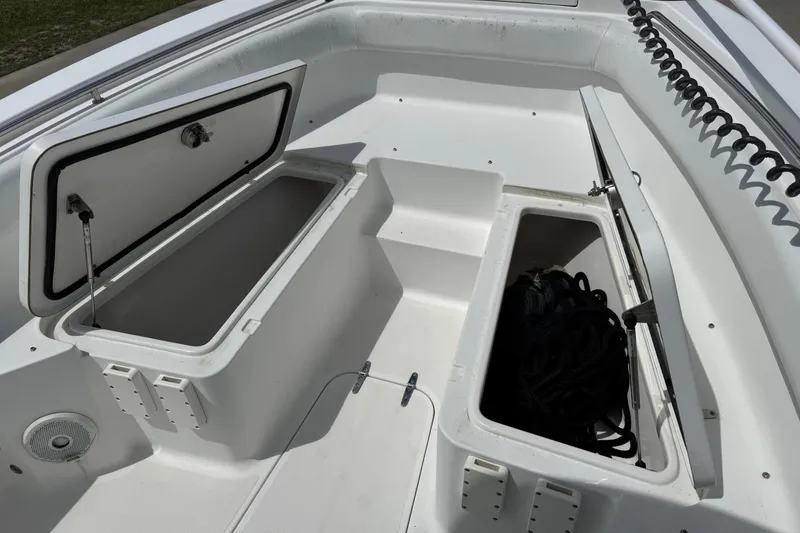 Slide: The Image of 2014 Sea Hunt Gamefish 25 boat with open storage compartments on deck. - 8