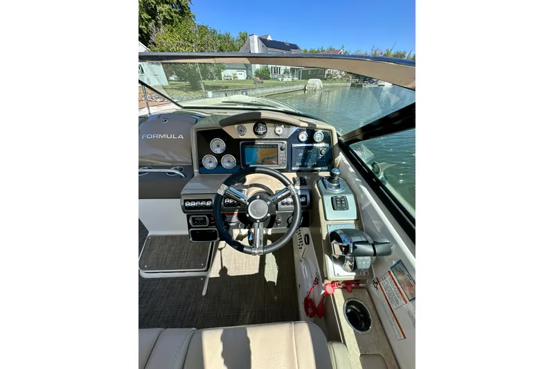 Slide: The Image of Cockpit view of 2015 Formula 350 Crossover Bowrider I/O, featuring steering wheel and controls. - 12