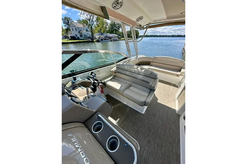 Slide: The Image of 2015 Formula 350 Crossover Bowrider I/O interior with seating, on a scenic lake. - 13