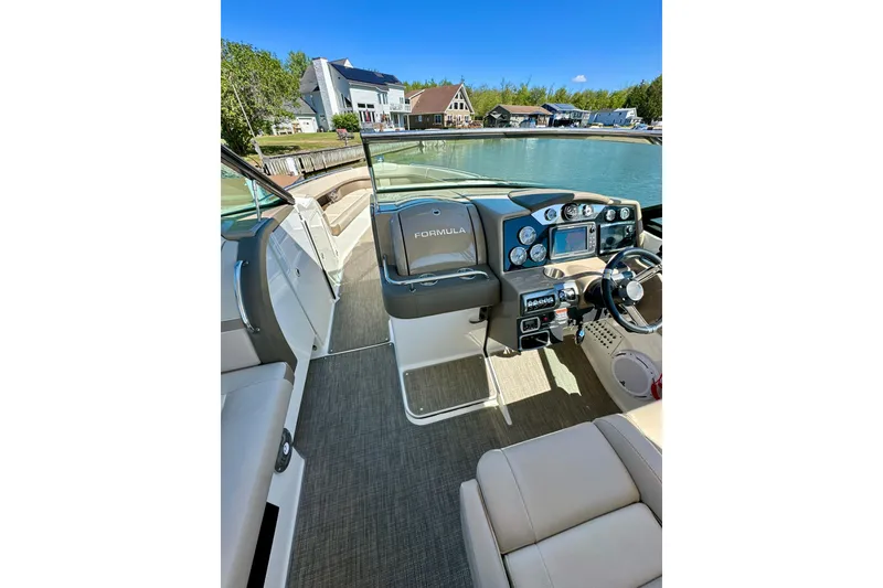 Slide: The Image of 2015 Formula 350 Crossover Bowrider I/O interior with modern dashboard and waterfront view. - 15