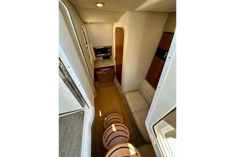 Slide: The Image of Interior of 2015 Formula 350 Crossover Bowrider I/O, featuring seating and kitchenette. - 16