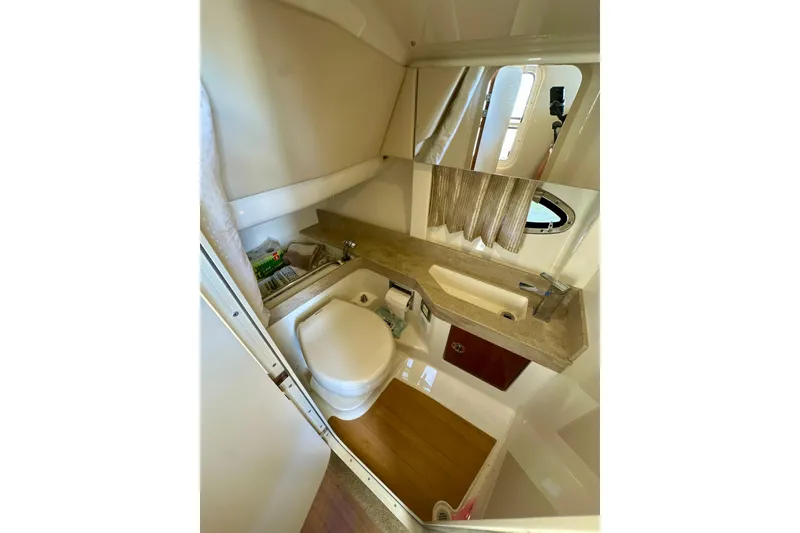 Slide: The Image of 2015 Formula 350 Crossover Bowrider I/O bathroom with sink, toilet, and mirror. - 18