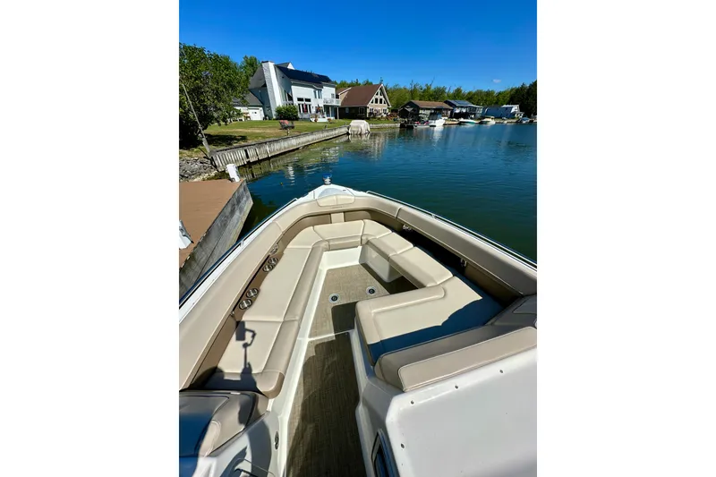 Slide: The Image of 2015 Formula 350 Crossover Bowrider I/O docked by waterfront homes. - 22