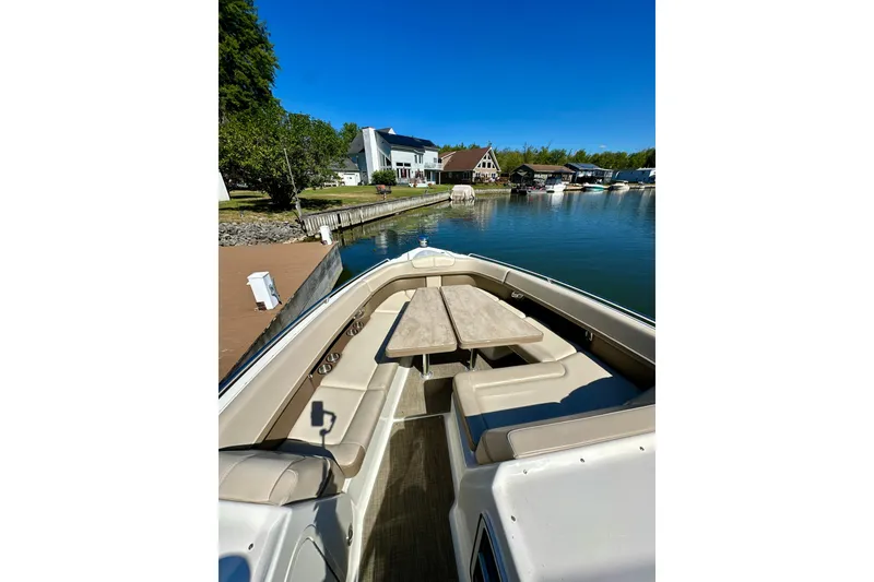 Slide: The Image of 2015 Formula 350 Crossover Bowrider I/O docked, featuring spacious seating and table. - 24