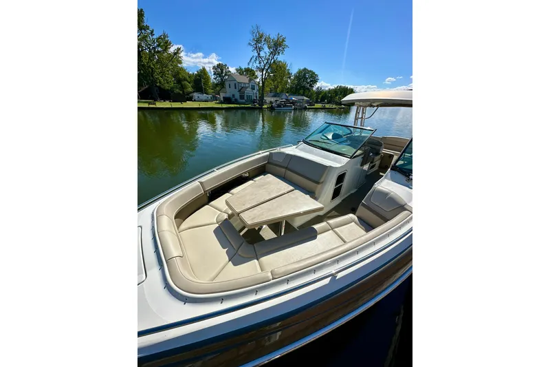 Slide: The Image of 2015 Formula 350 Crossover Bowrider I/O on a serene lake, featuring spacious seating. - 25