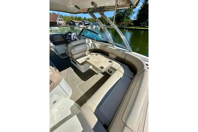 Slide: The Image of 2015 Formula 350 Crossover Bowrider I/O interior with seating and table on a sunny day. - 8
