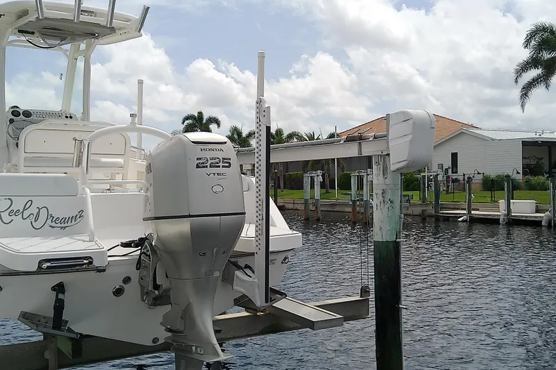 Slide: The Image of 2008 Everglades 210CC boat with Honda 225 VTEC engine docked by waterfront. - 12