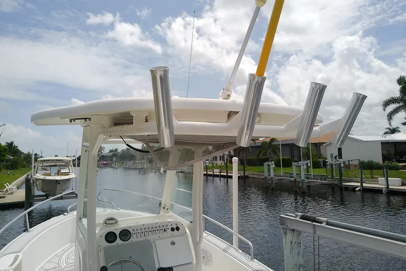 Slide: The Image of 2008 Everglades 210CC boat with rod holders, docked on a sunny day. - 15