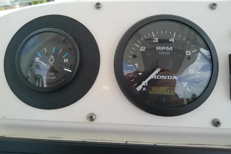 Slide: The Image of Close-up of 2008 Everglades 210CC boat gauges, showing temperature and RPM. - 18