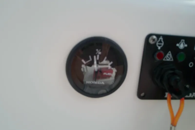 Slide: The Image of Close-up of a Honda fuel gauge on a 2008 Everglades 210CC boat dashboard. - 19