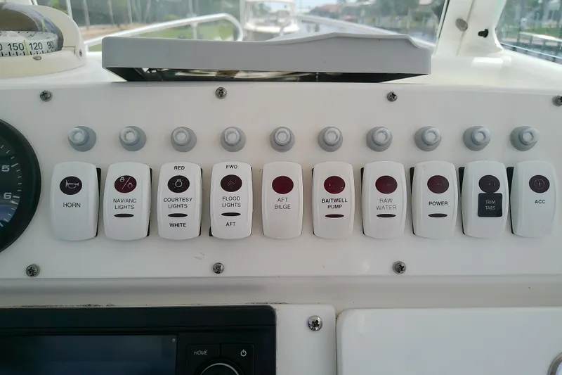 Slide: The Image of Control panel of a 2008 Everglades 210CC boat with labeled switches and gauges. - 20