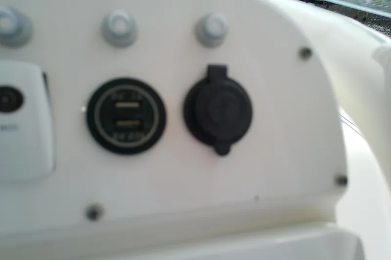 Slide: The Image of Dashboard of 2008 Everglades 210CC boat with USB ports and controls. - 21