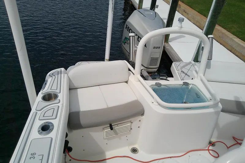 Slide: The Image of 2008 Everglades 210CC boat with Honda 225 engine, docked by the water. - 30