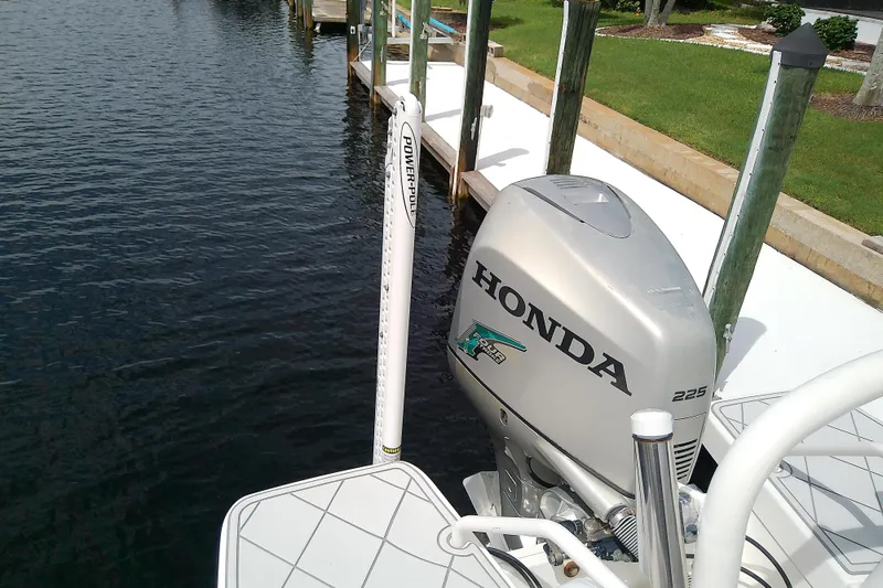 Slide: The Image of 2008 Everglades 210CC boat with Honda 225 outboard motor docked by water. - 36
