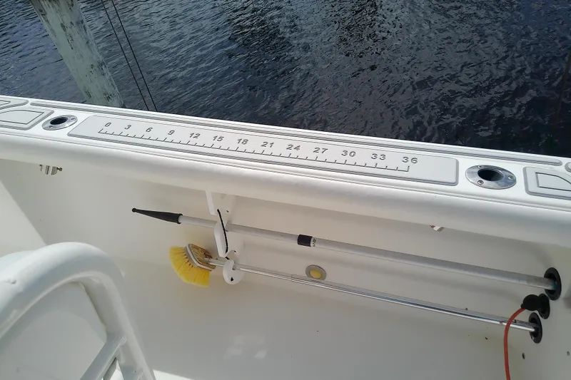 Slide: The Image of 2008 Everglades 210CC boat interior with measuring ruler and cleaning brush. - 37