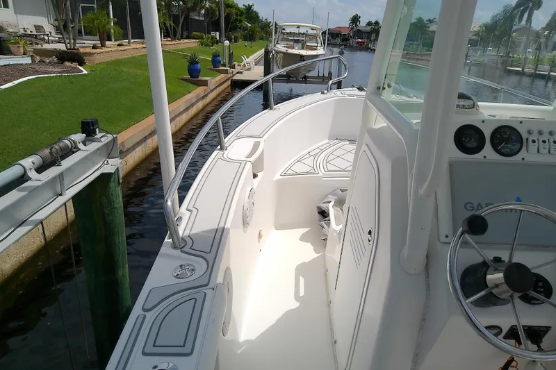 Slide: The Image of 2008 Everglades 210CC boat docked in a scenic canal setting. - 39