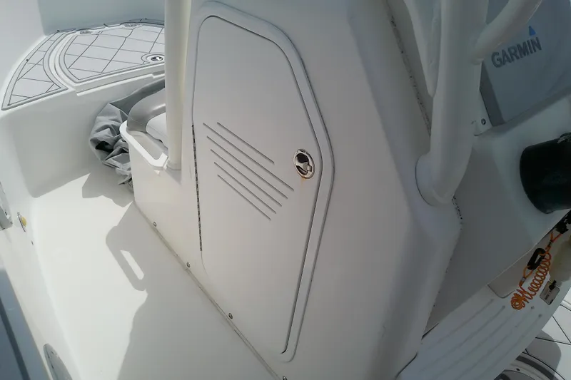 Slide: The Image of 2008 Everglades 210CC boat interior with Garmin equipment and storage compartment. - 41