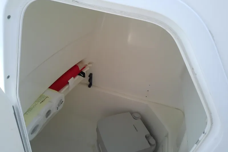 Slide: The Image of Storage compartment in 2008 Everglades 210CC boat with safety equipment and supplies. - 43