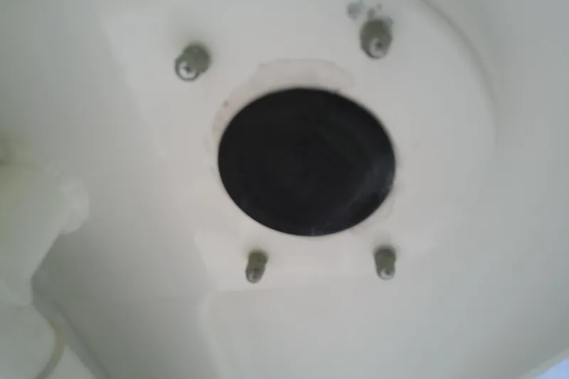 Slide: The Image of Close-up of a 2008 Everglades 210CC boat component with bolts and a black circular part. - 45