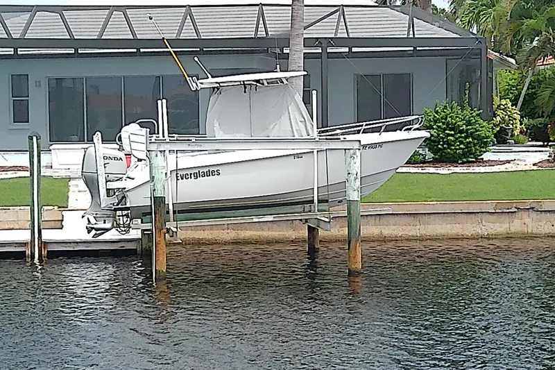 Slide: The Image of 2008 Everglades 210CC boat on lift by waterfront home. - 5