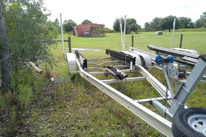 Slide: The Image of Trailer for 2008 Everglades 210CC boat parked on grassy field. - 50
