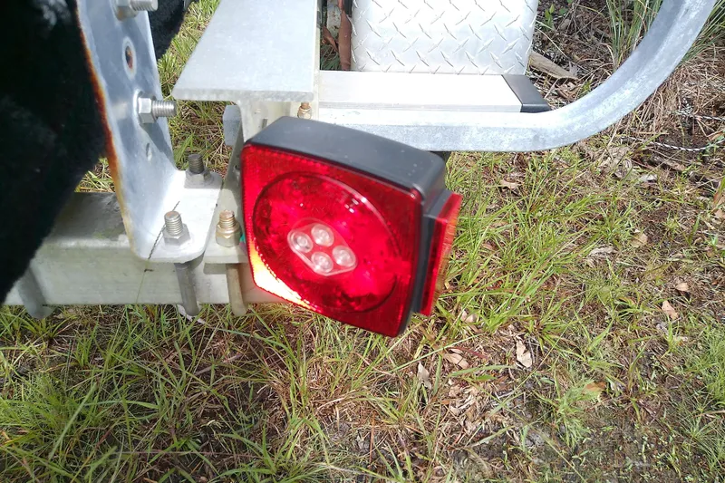 Slide: The Image of Trailer tail light on Everglades 210CC boat trailer, 2008 model, parked on grass. - 56