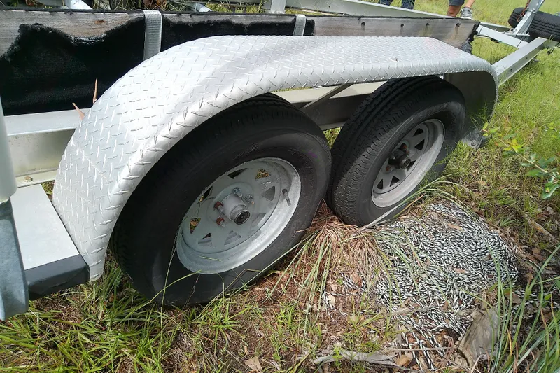 Slide: The Image of Trailer with dual wheels on grass, featuring diamond plate fender, Everglades 210CC 2008 model. - 57