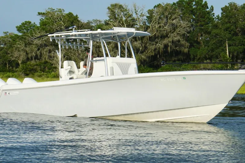 Slide: The Image of 2022 Contender 35 ST boat on calm water with lush green background. - 10