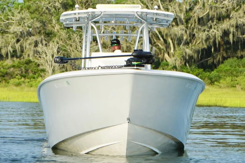 Slide: The Image of 2022 Contender 35 ST boat cruising on a calm river with lush greenery. - 11