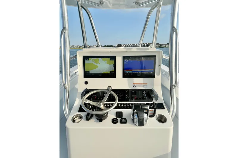 Slide: The Image of 2022 Contender 35 ST boat console with dual navigation screens and steering wheel. - 13