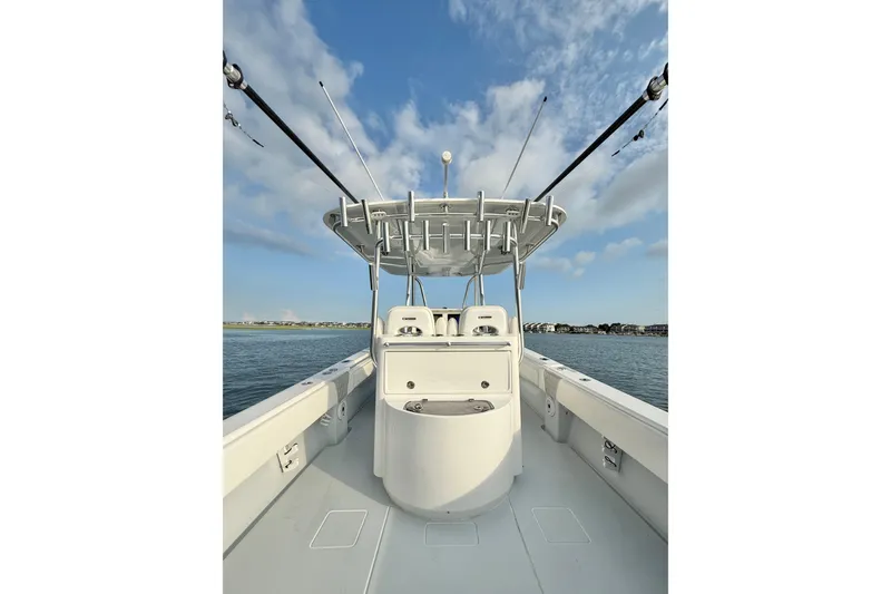 Slide: The Image of 2022 Contender 35 ST boat on water, clear sky, fishing rods visible. - 16