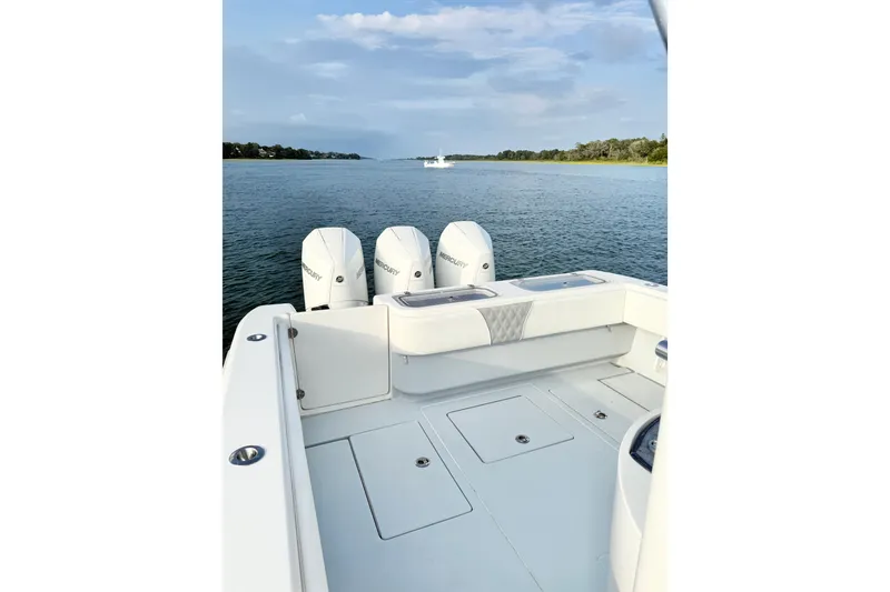 Slide: The Image of 2022 Contender 35 ST boat with triple Mercury engines on a calm waterway. - 17