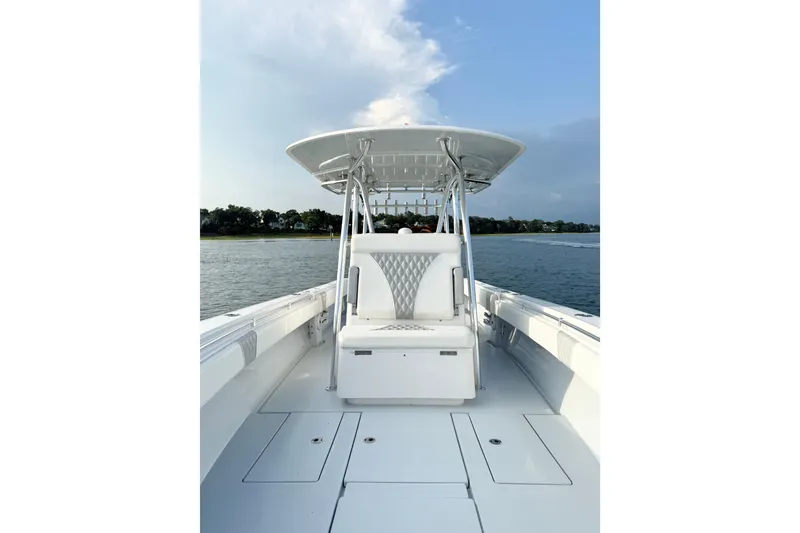 Slide: The Image of 2022 Contender 35 ST boat on water, featuring sleek white design and spacious deck. - 18