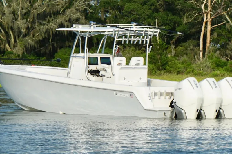 Slide: The Image of 2022 Contender 35 ST boat with triple Mercury engines on a calm waterway. - 8