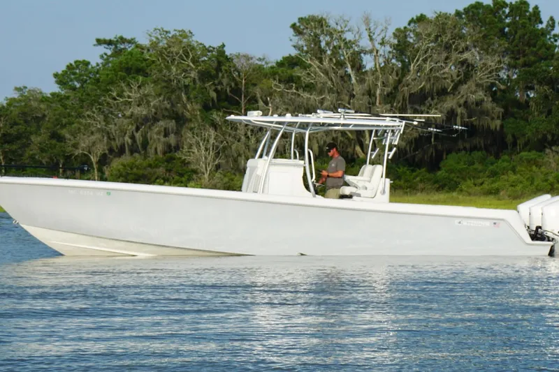 Slide: The Image of 2022 Contender 35 ST boat on water, with trees in the background. - 9