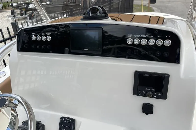 Slide: The Image of 2025 Pioneer 202 Sportfish dashboard with controls, steering wheel, and electronic display. - 10
