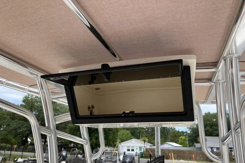 Slide: The Image of 2025 Pioneer 202 Sportfish boat with overhead storage compartment and canopy. - 12