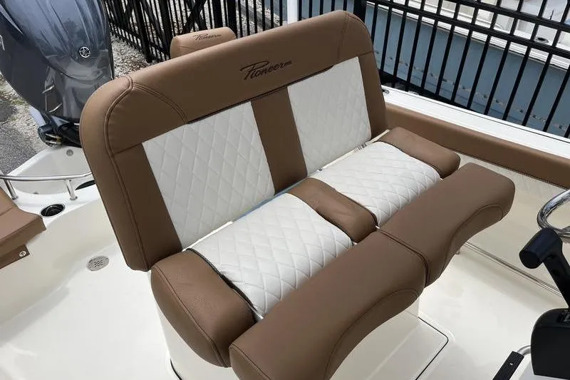 Slide: The Image of 2025 Pioneer 202 Sportfish boat with tan and white cushioned seating. - 14
