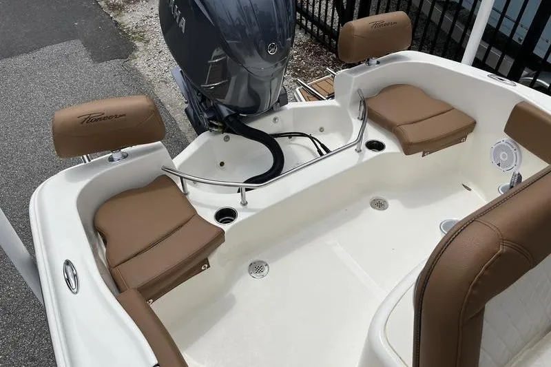 Slide: The Image of 2025 Pioneer 202 Sportfish boat interior with tan seating and Yamaha outboard motor. - 16