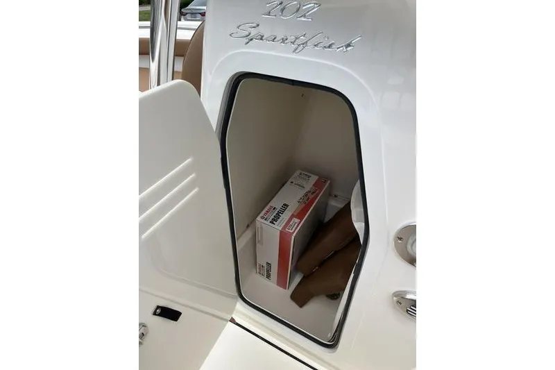 Slide: The Image of 2025 Pioneer 202 Sportfish storage compartment with propeller box inside. - 19
