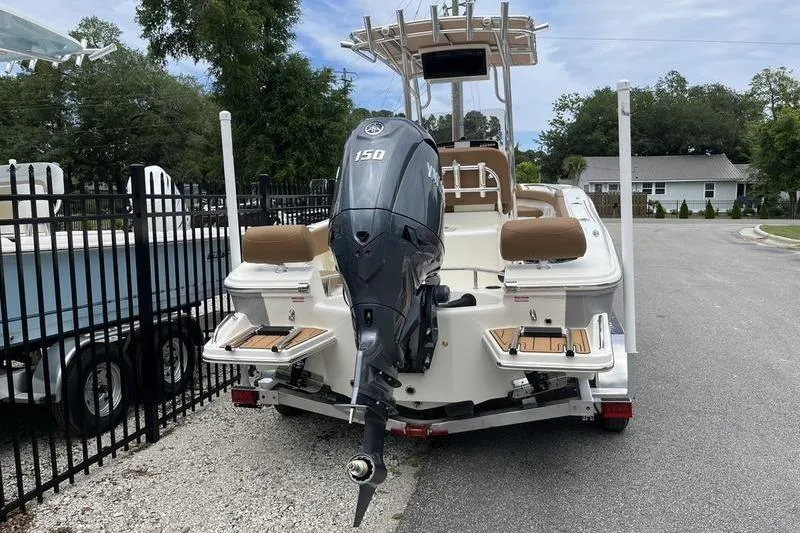 Slide: The Image of 2025 Pioneer 202 Sportfish boat with Yamaha 150 engine, parked on a trailer. - 3