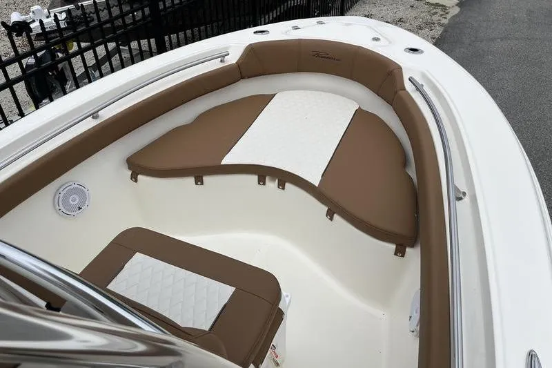 Slide: The Image of 2025 Pioneer 202 Sportfish boat interior with brown and white cushioned seating. - 4
