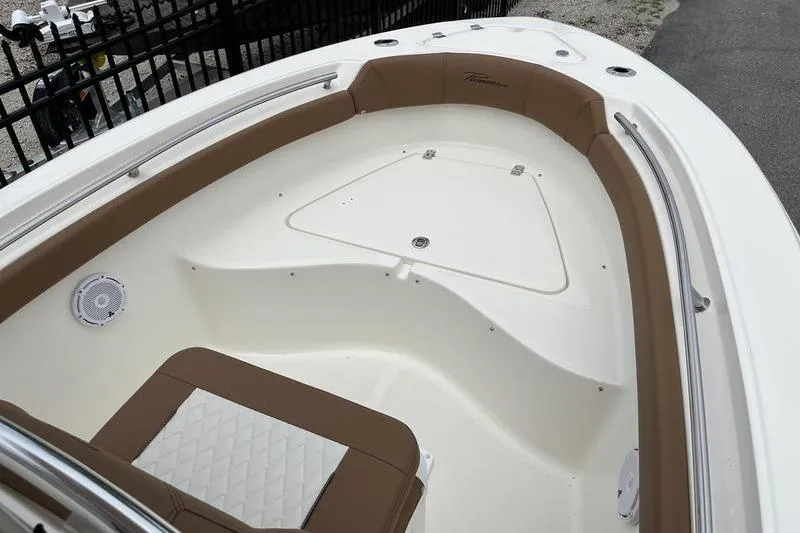Slide: The Image of 2025 Pioneer 202 Sportfish boat interior with brown seating and white deck. - 5